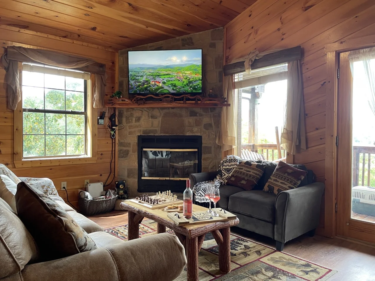 Rustic pet friendly cabin Sevierville living room with stone fireplace and mountain views
