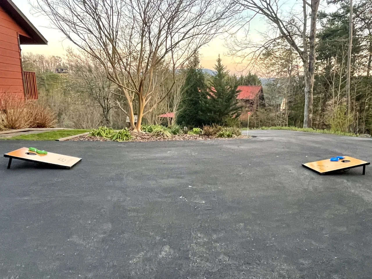 Cornhole on the lawn at a Pigeon Forge Tennessee cabin with a wooded ridge view, Serenity View cabin USA getaway