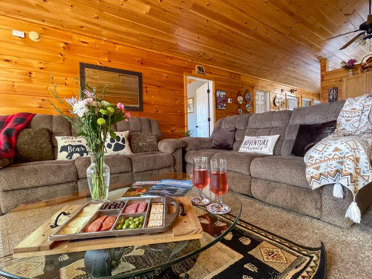 Log cabin living room with gray sectional seating at a Pigeon Forge Tennessee vacation cabin