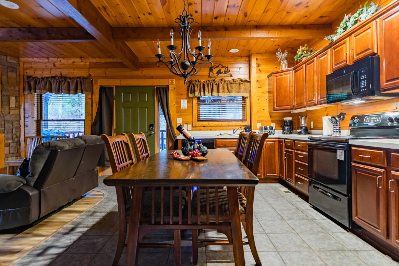 Rustic cabin kitchen with wood beams, open-concept dining area, and mountain views at Smoky Mountain Escape near Gatlinburg
