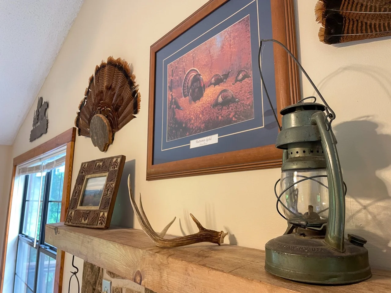 Cabin game room with pool table and foosball near Sevierville, TN: rustic wildlife art, carved turkey plaque, and antler