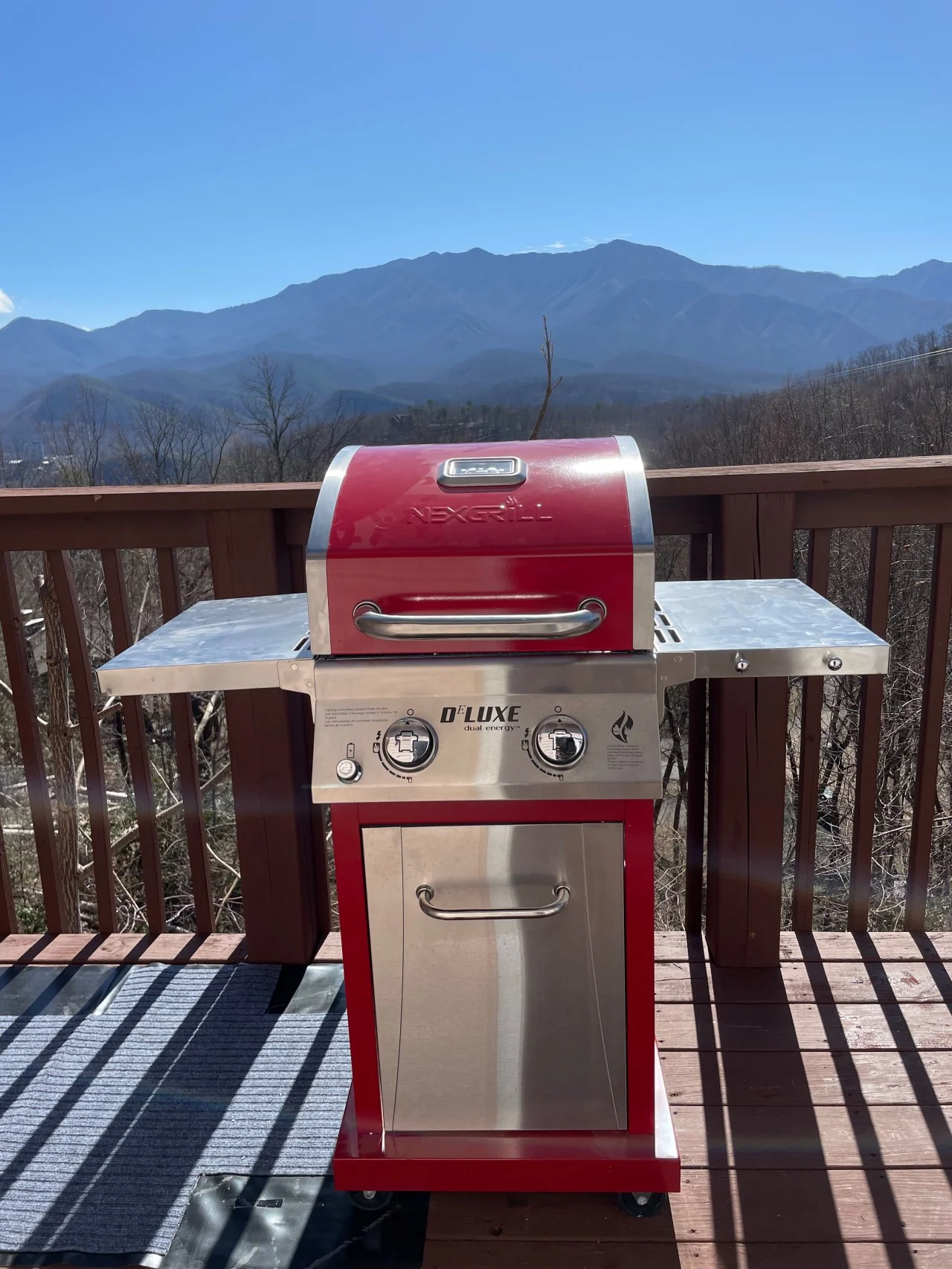 Red stainless steel grill on wooden deck with panoramic mountain views at Gatlinburg cabin