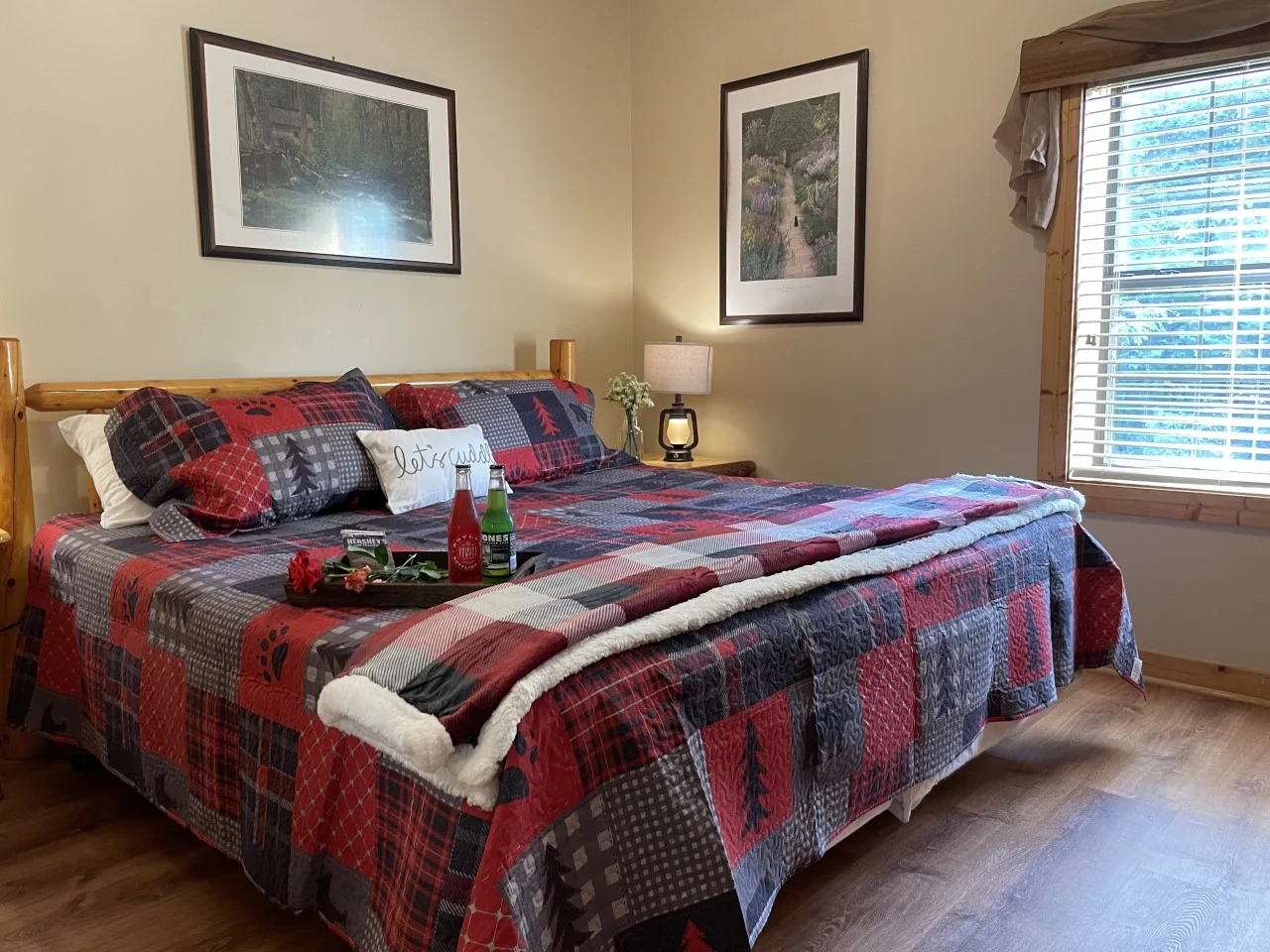 Honey Bear Sevierville, TN cabin bedroom with plaid bedding and a wooden bed frame