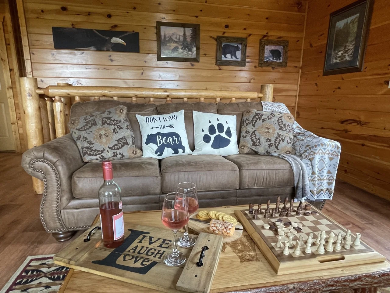 Log cabin living room with bear pillows and chess set for rainy day activities Gatlinburg stays