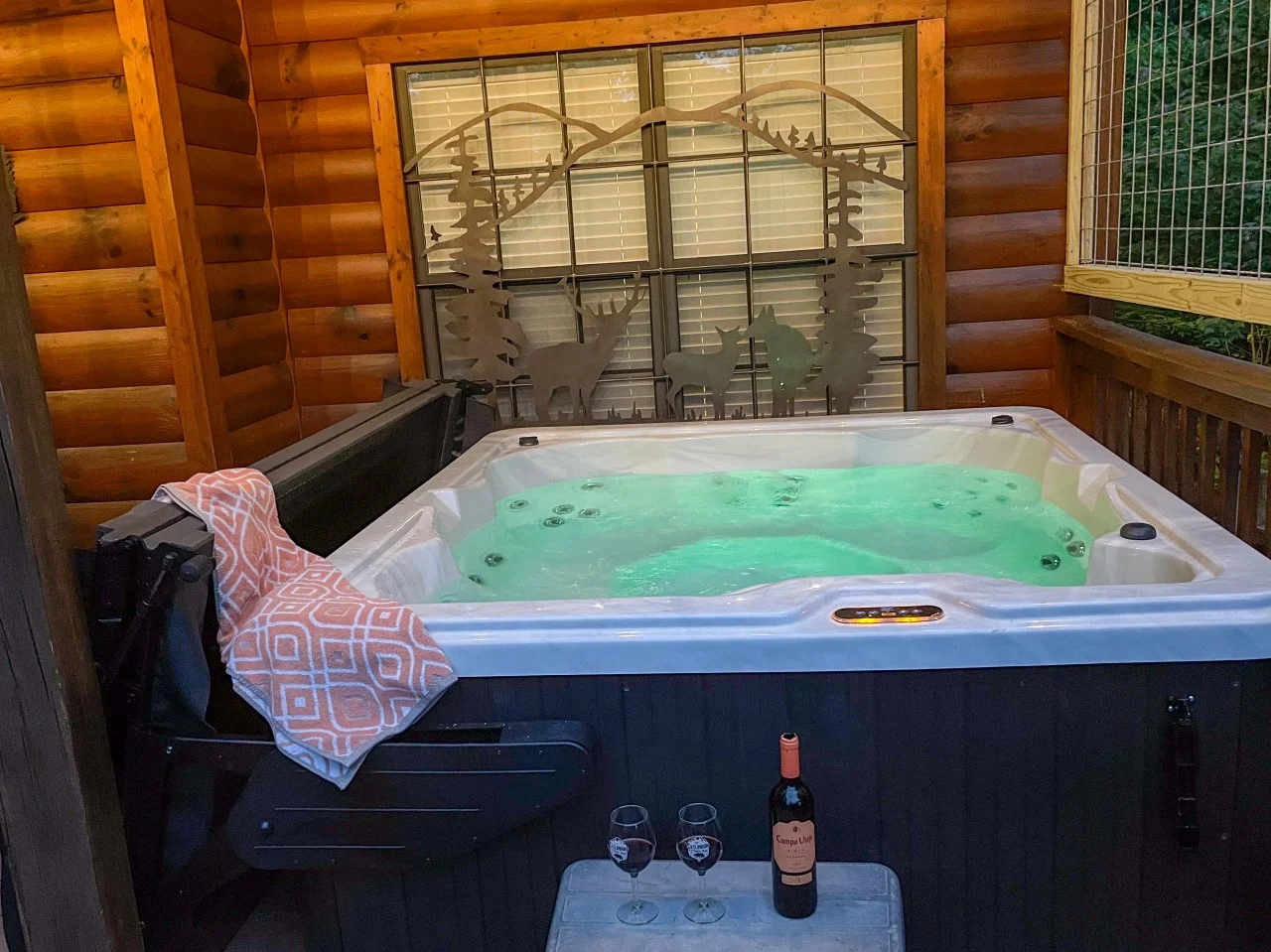 Private hot tub on a log cabin patio at Summit Up Sevierville, TN